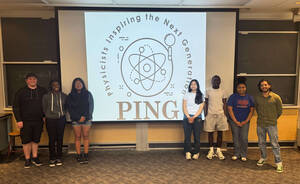 Graduate student Fabio Rivero and five local high school students stand in front of a projector that says Physicists Inspiring the Next Generation.